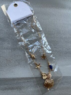 Gold Seashell Charm Necklace with Blue Accent